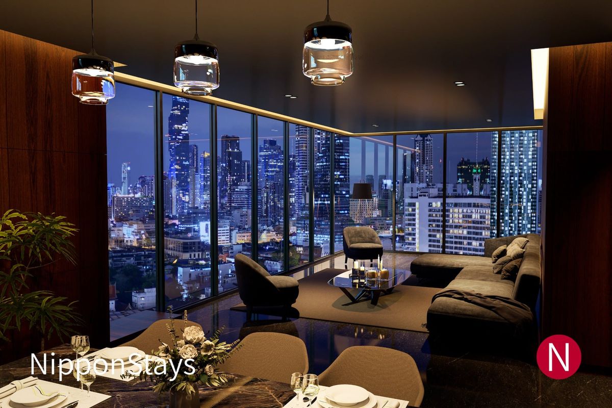 A modern high-floor interior with floor-to-ceiling windows over a night city