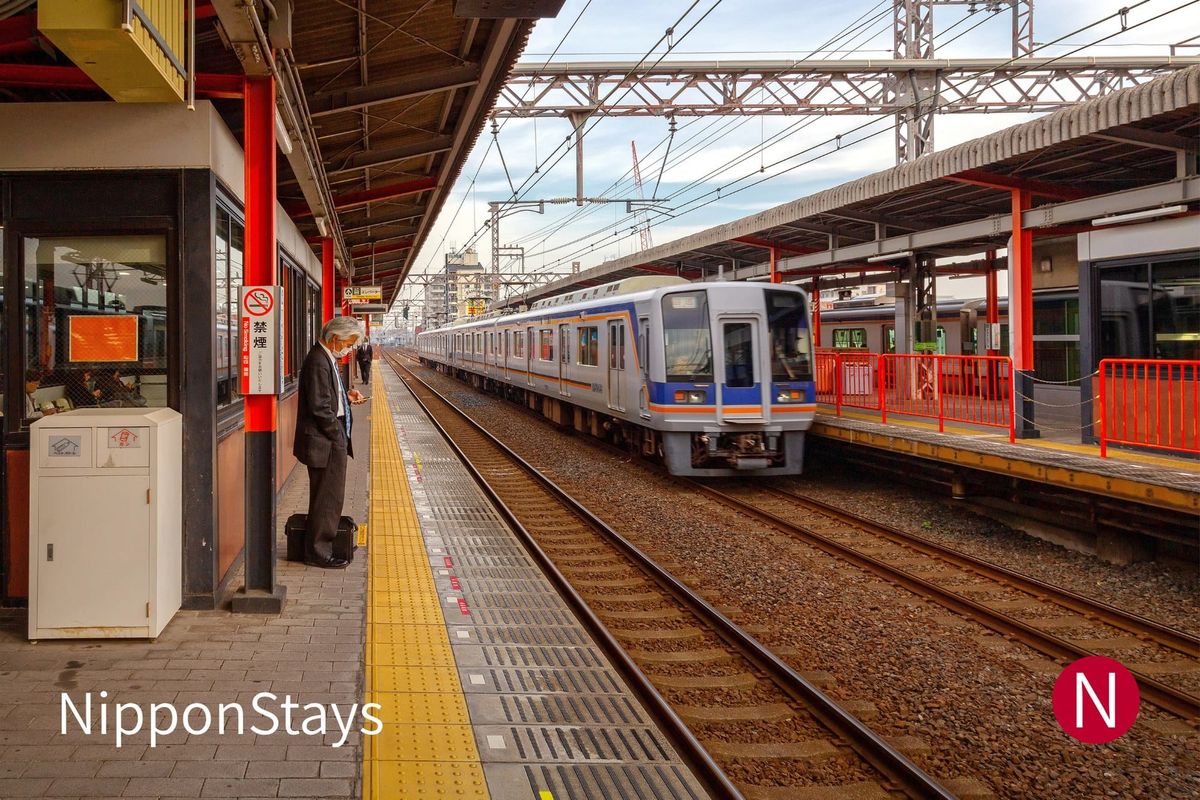 A commuter train arriving at a Japanese station platform