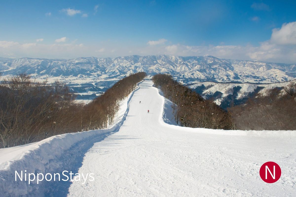 A groomed ridge run at Nozawa Onsen with the Nagano ranges beyond