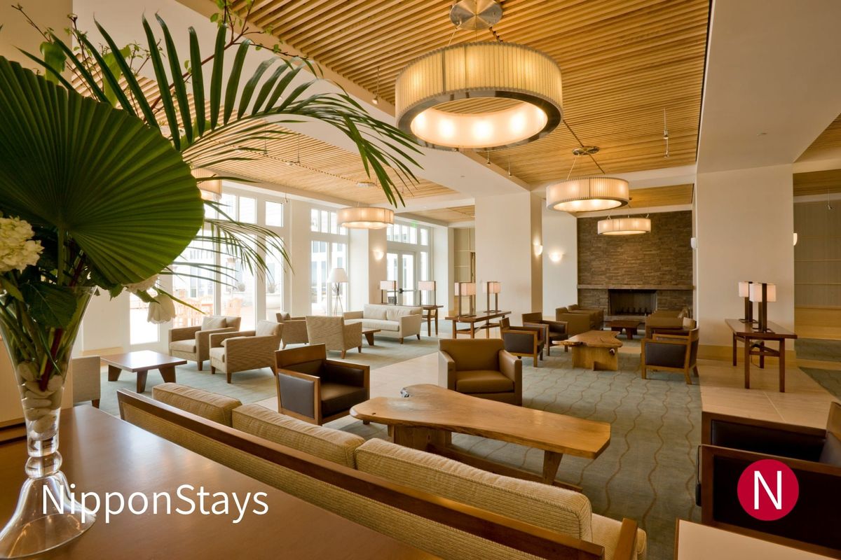 A hotel lobby with seating and a reception counter