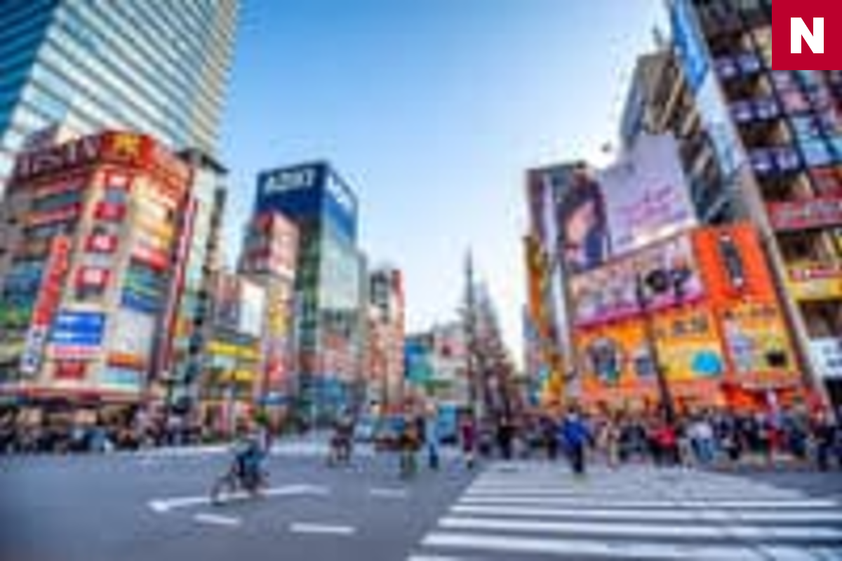 A broad Akihabara crossing with pedestrians in Tokyo.