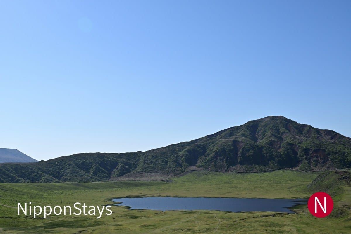 The Kusasenri grassland and its pond below the Aso peaks in Kumamoto