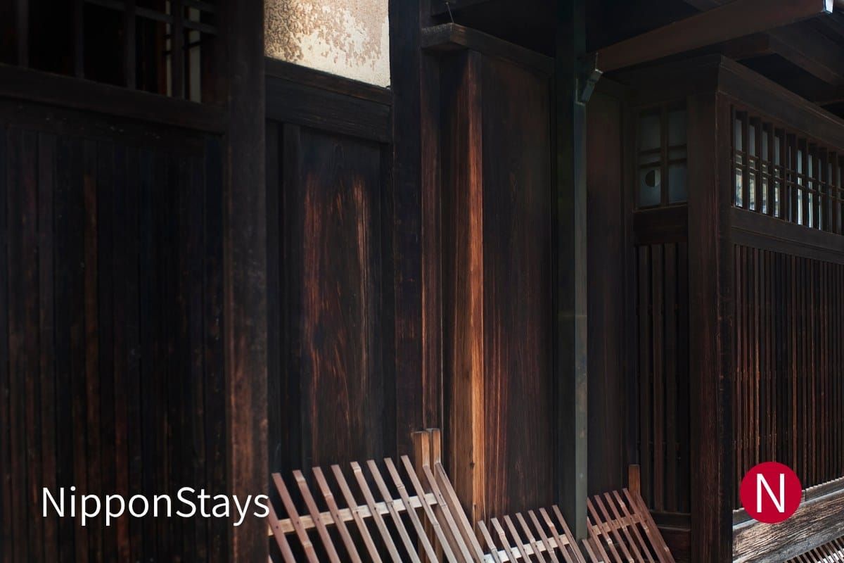 Dark wooden lattice facade and entrance of a traditional Kyoto machiya