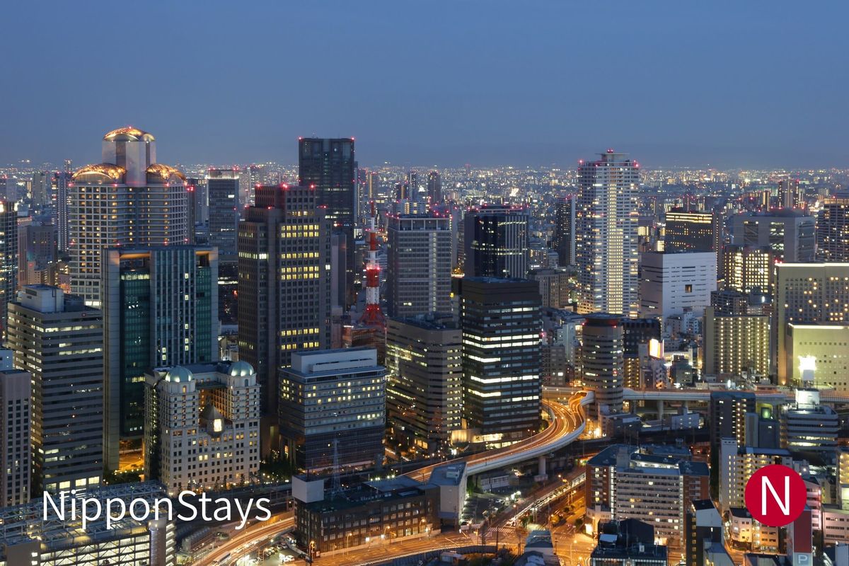 Osaka skyline at dusk with high-rise hotels and an expressway curving between them