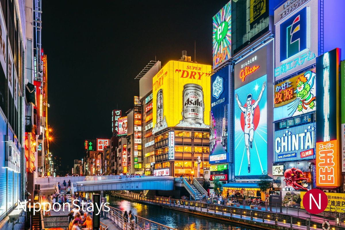 Dotonbori canal at night with the Glico running-man sign and Ebisubashi bridge