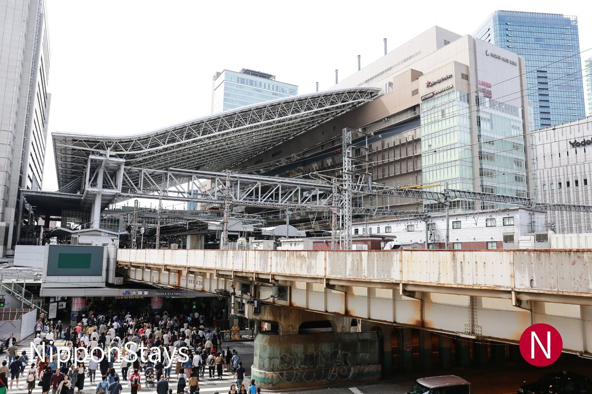 JR Osaka Station north side with crowds crossing beneath the elevated tracks