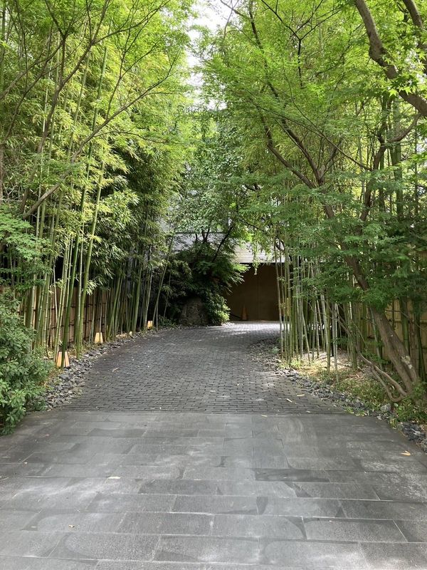 The stone-paved bamboo-lined approach to FUFU Kyoto in the Okazaki district