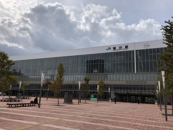 The glass facade of JR Asahikawa Station and its wide station plaza