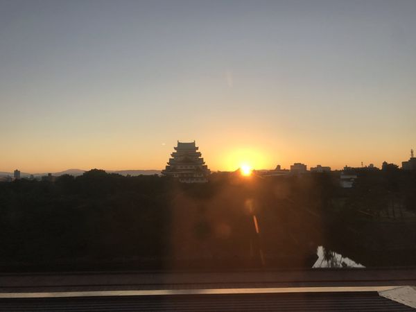 Nagoya Castle keep at sunset with the city skyline
