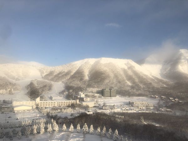 Rusutsu Resort and its ski runs below the hotel towers on a clear winter morning