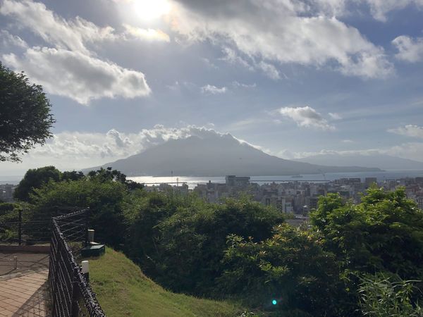 Sakurajima volcano across Kinko Bay, seen over the Kagoshima city skyline from the Shiroyama viewpoint