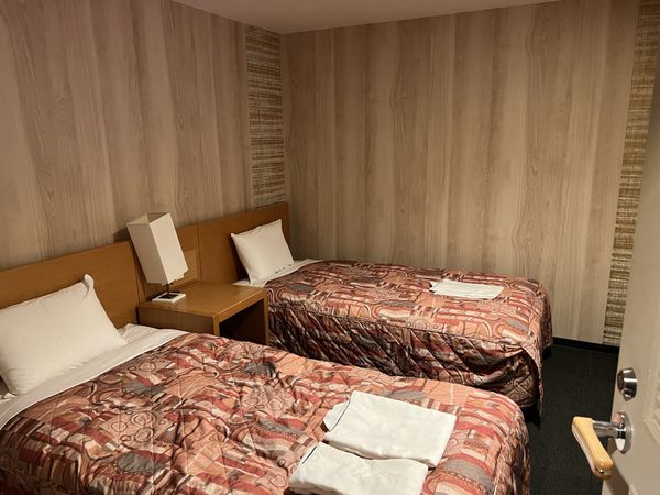 Twin-bed guest room with patterned bedspreads at Tomamu The Tower