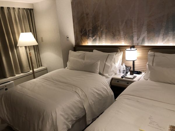 Twin-bed guest room with a birch-forest headboard mural at The Westin Rusutsu Resort