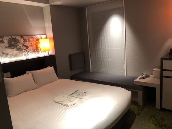 A compact double room in a Kyoto business hotel, with the bed filling most of the floor