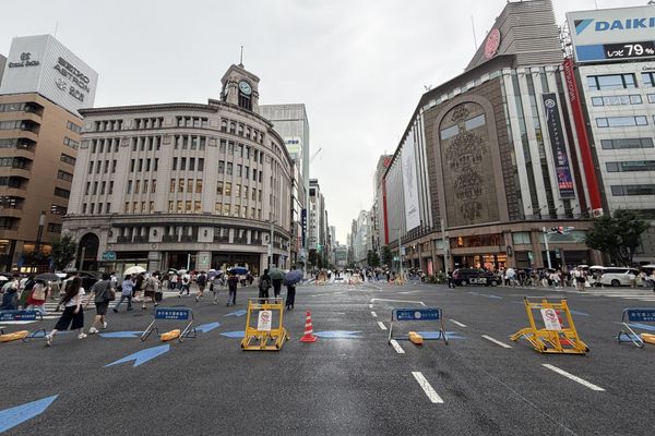 Chuo-dori in Ginza closed to traffic on a weekend afternoon, with the Wako clock tower at the 4-chome crossing