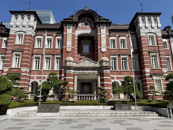 The Tokyo Station Marunouchi building's red-brick facade under a clear sky
