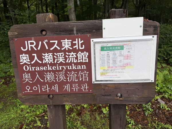 JR Bus Tohoku stop sign and timetable at Oirase Keiryukan in Aomori, with English notice that the Japan Rail Pass is valid