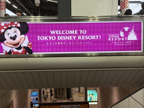 Welcome to Tokyo Disney Resort banner above the concourse at Maihama Station