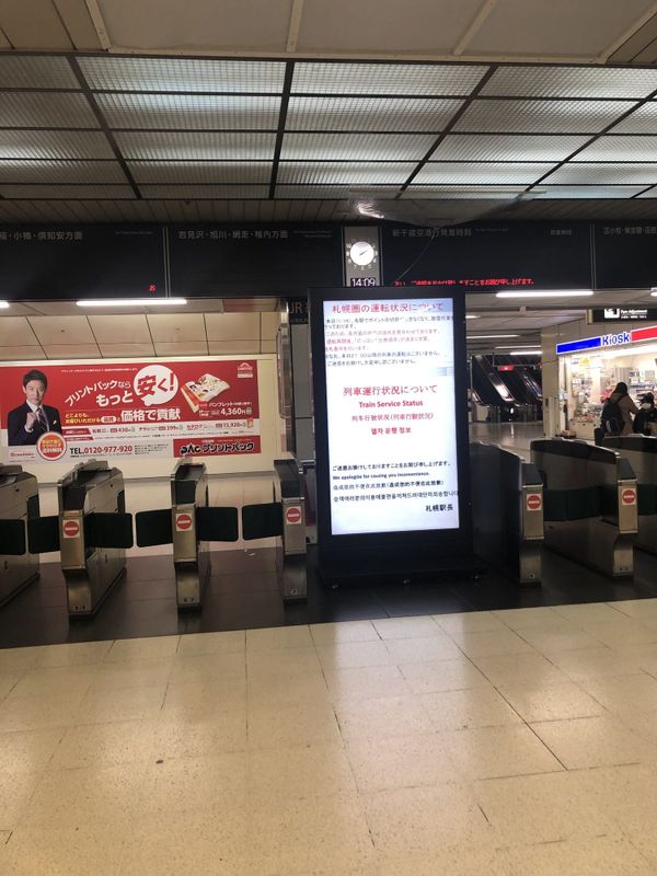 Train service status board at Sapporo Station announcing suspensions after heavy snow