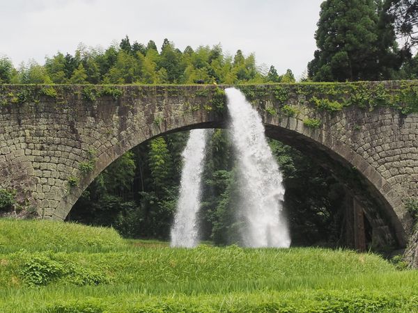 Water discharging from the stone arch of Tsujun Bridge in Yamato, Kumamoto