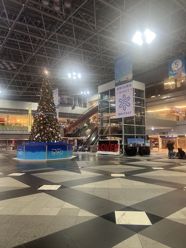 The atrium of New Chitose Airport in December with a large decorated tree