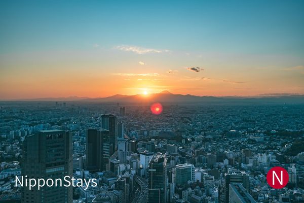 Aerial view of Shibuya, Tokyo at dusk with the city lights coming on