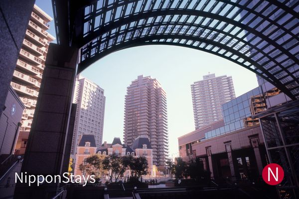The glass arch of Ebisu Garden Place with the tower behind it