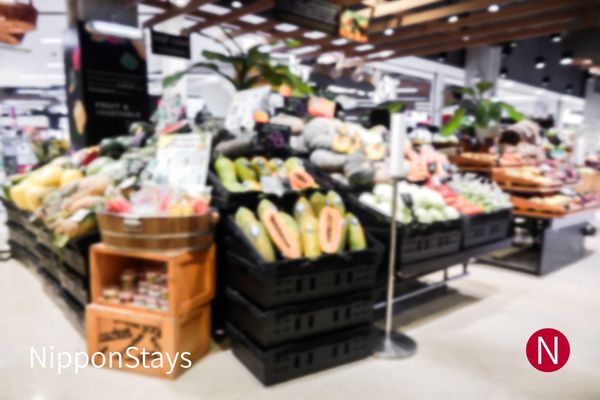 Fruit and vegetable section of a supermarket, produce stacked in crates