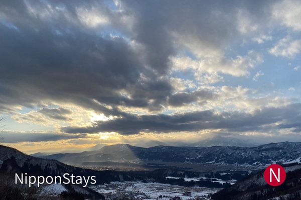 Cloud breaking over snow-covered mountains above Nozawa Onsen