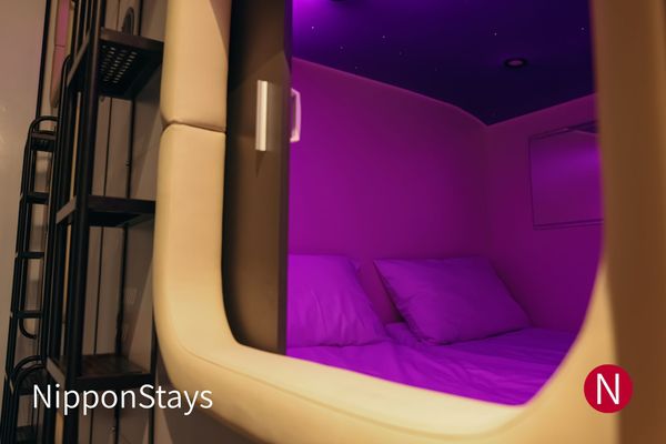 A modern sleeping pod with its privacy screen open