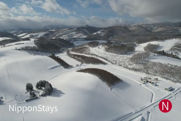Rolling snow-covered farmland between Furano and Biei