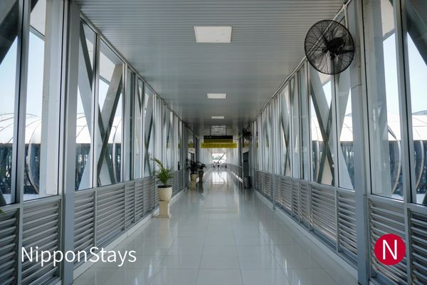An elevated walkway leading into an airport terminal