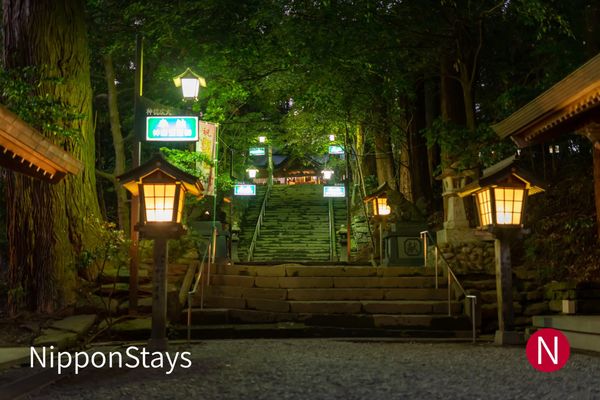 Lanterns lighting the approach to Takachiho Shrine at night