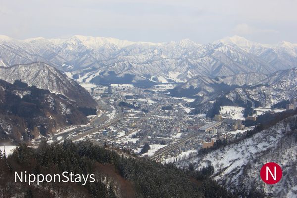 The view down over a snow-covered valley town from the Gala Yuzawa ski area