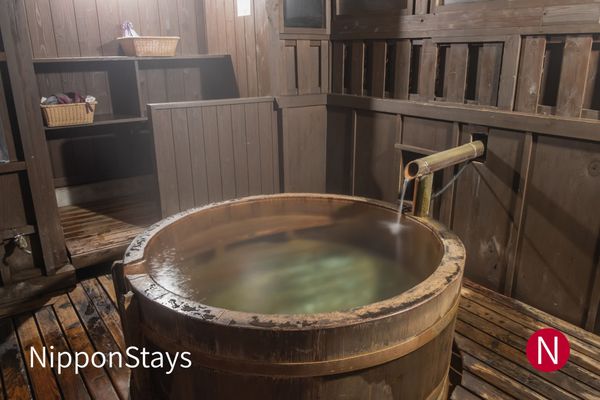 A wooden barrel bath in a private guest room
