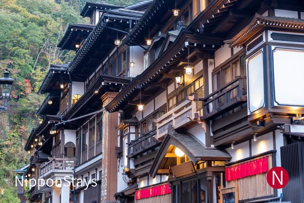Wooden ryokan buildings and lanterns in an onsen town