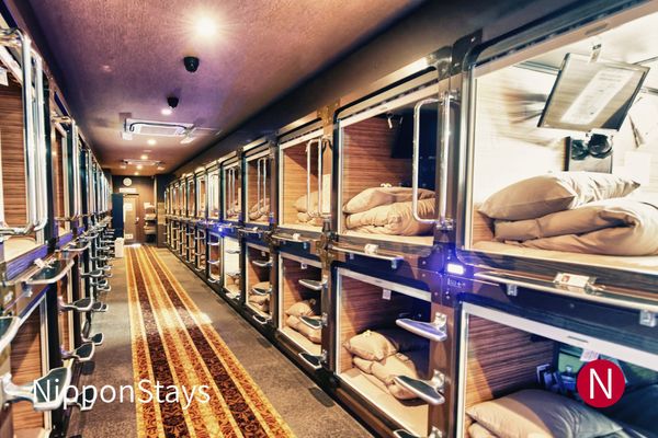 Sleeping pods along a capsule hotel corridor