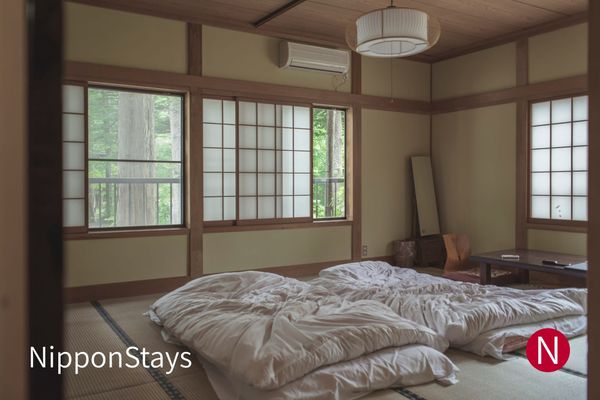 Futons laid out on tatami in a traditional ryokan room