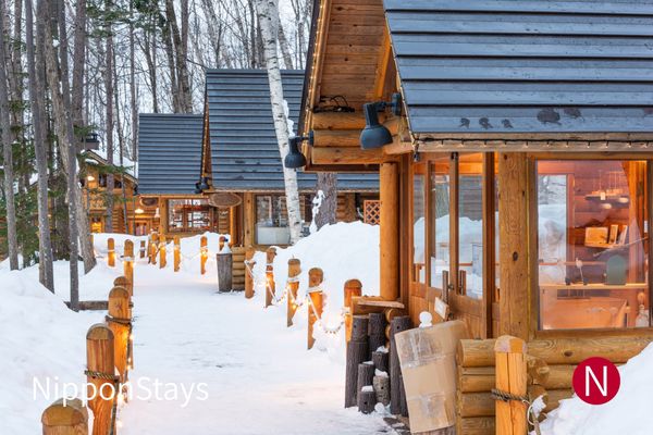 Lit wooden cabins under deep snow at Furano in Hokkaido