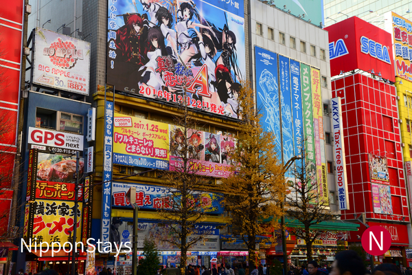 Anime billboards and game-store signs covering buildings in Akihabara.