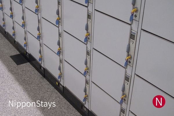 A bank of coin lockers with yellow keys in a Japanese station