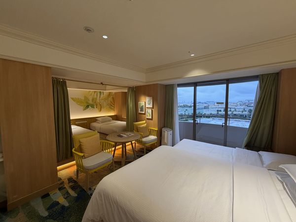 Sheraton Grande Tokyo Bay family room with a king bed, a curtained twin alcove and a balcony facing the Disney Resort Line