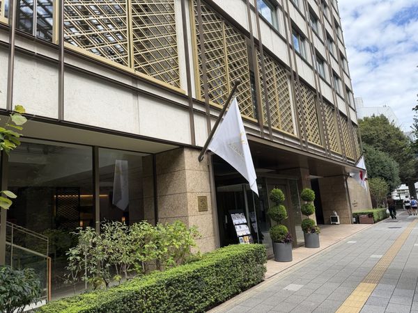 The Kitano Hotel Tokyo entrance, with a brass Relais & Châteaux plaque and the gold lattice screen above.