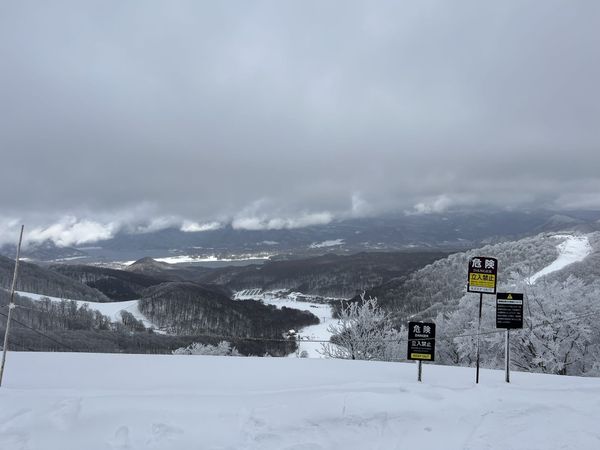 The managed-area boundary rope and DANGER / KEEP OUT signs on the summit ridge at Nekoma Mountain, looking north over Lake Hi