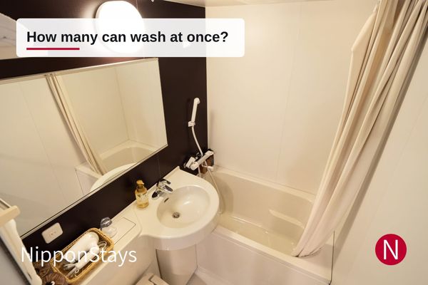 A Japanese three-piece unit bath with the tub, basin and toilet moulded into one small room