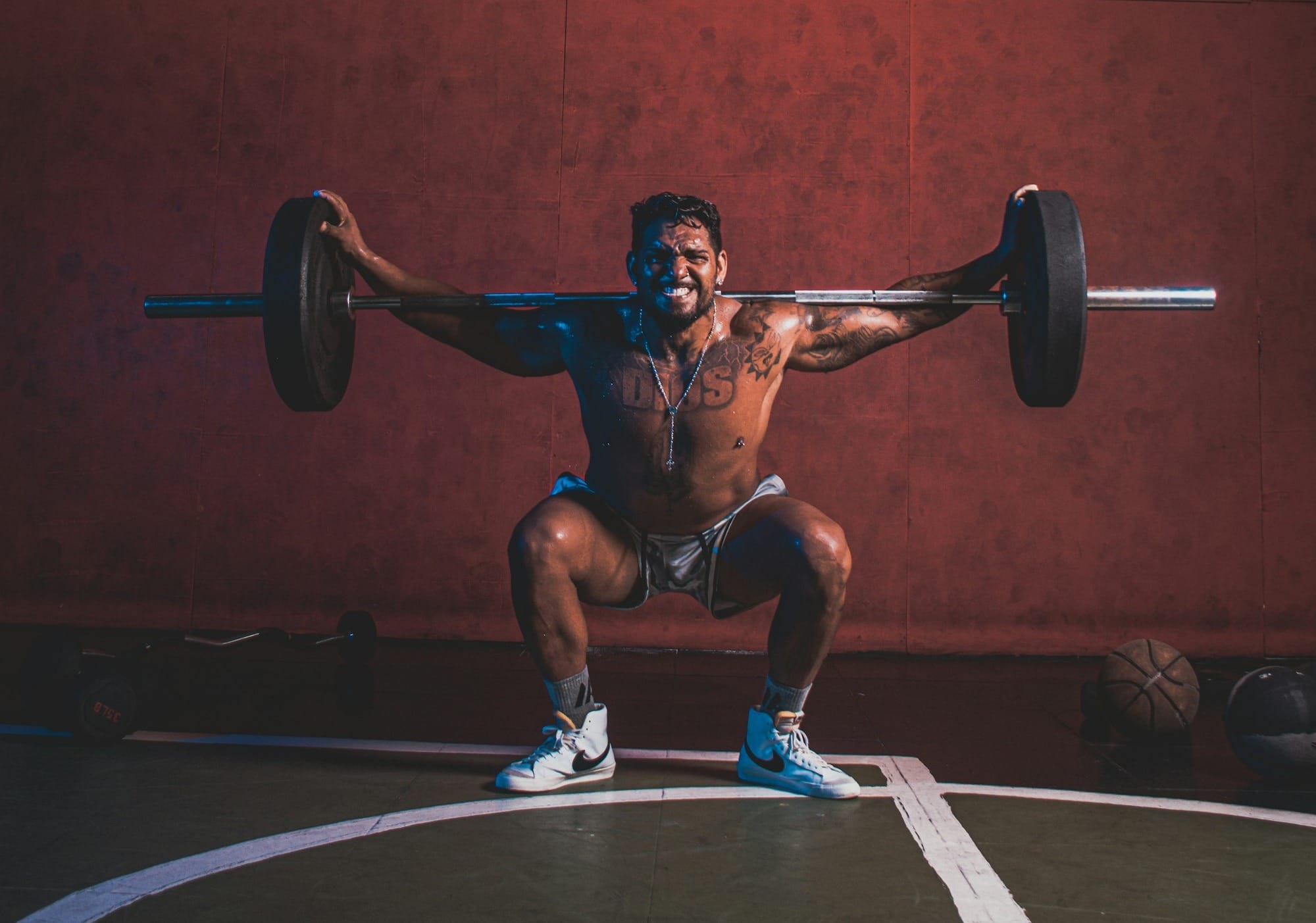 a man doing a squat with a barbell