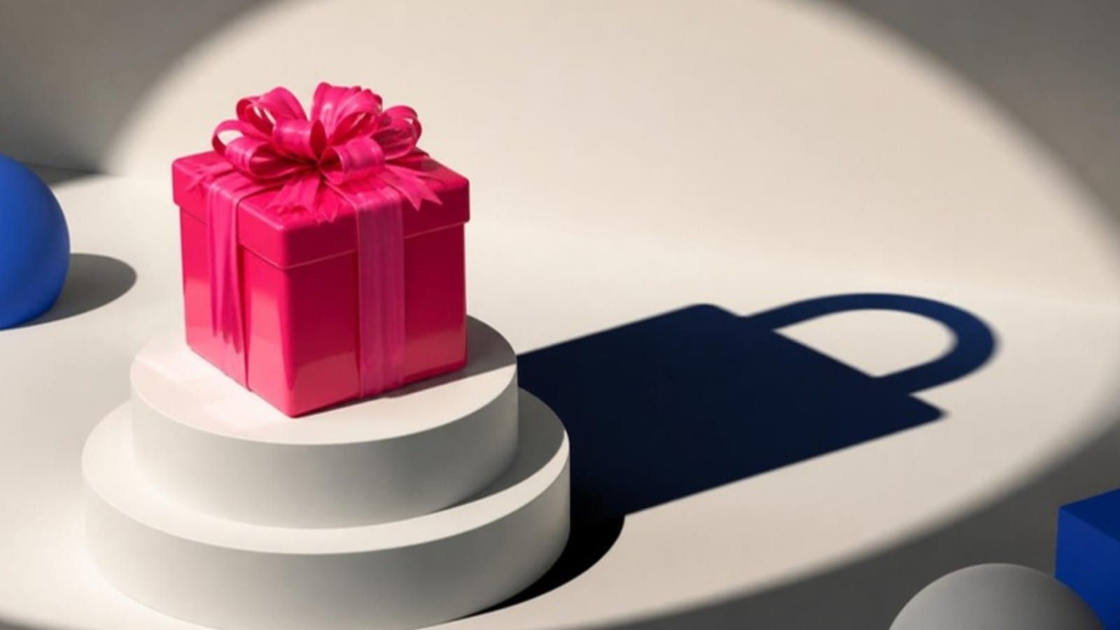 A pink gift-wrapped box on a pedestal casts a shadow shaped like a padlock.