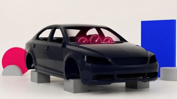 A navy car with no wheels sits on concrete blocks while its dashboard gauges glow at maximum.