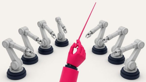 A pink hand raises a conductor's baton over a semicircle of grey robot arms.