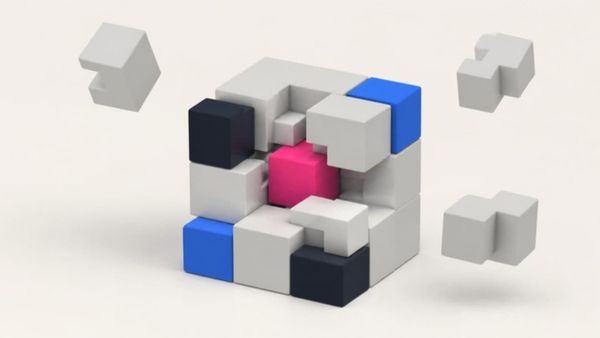 A pink cube at the center of a larger block of grey and blue modules, some pieces floating free.